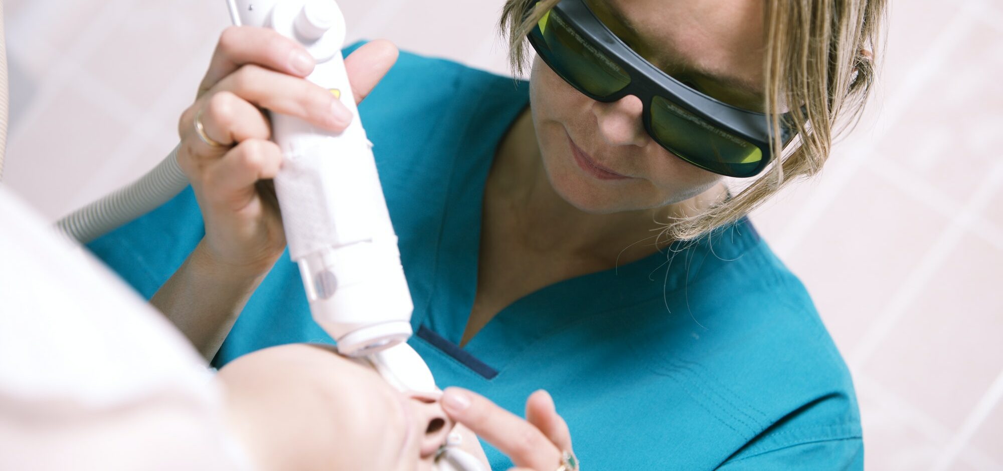 Beautician doing laser skin treatment